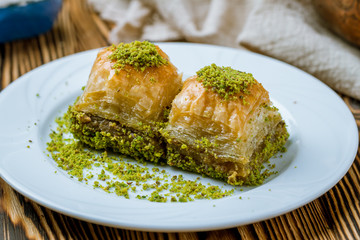 baklava with pistachios on wooden table. Turkish cuisine