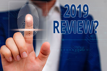 Handwriting text 2019 Review Question. Conceptual photo remembering past year events main actions or good shows Male human wear formal work suit presenting presentation using smart device