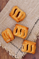 Puff pastry filled with appicot jam on a wooden table