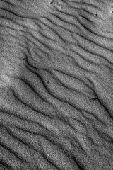 TEXTURE AND FORMS OF BEACH SAND. BLACK AND WHITE PHOTOGRAPHY