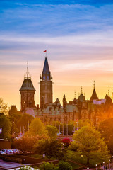 View of Ottawa city buildings and Rideau canal from Mackenzie King bridge during sunset - obrazy, fototapety, plakaty