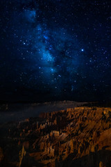 The milky way over bryce canyon national park hoodoos at night