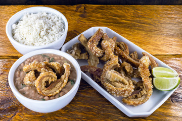 Traditional Brazilian recipe for pork crackling called pork crackling. Traditional Brazilian food, fried and crispy pork accompanied by bean tutu.