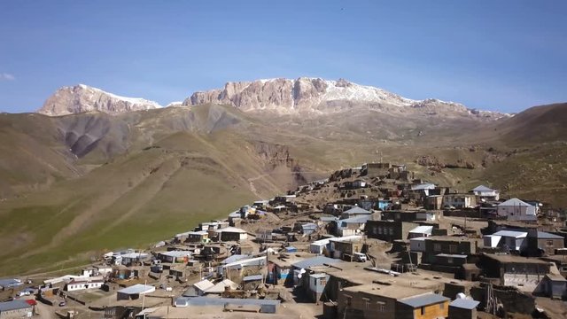 Aerial Fly Over Ancient Village In The Mountains On A Sunny Day