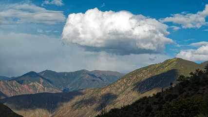 Fototapeta premium Big white clouds over mountains, rain clouds.