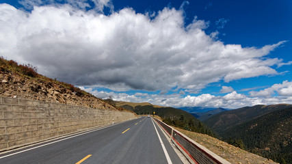 318 National road to Tibet with blue sky and white cloud, most beautiful road for Self-driving travelling.