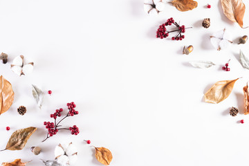 Autumn composition. autumn leaves, red berries, acorn nuts and white cotton head on white background. Flat lay, top view copy space.