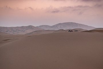 Fototapeta na wymiar Huacachina a world with buggy desert oasis and dunes of Peru