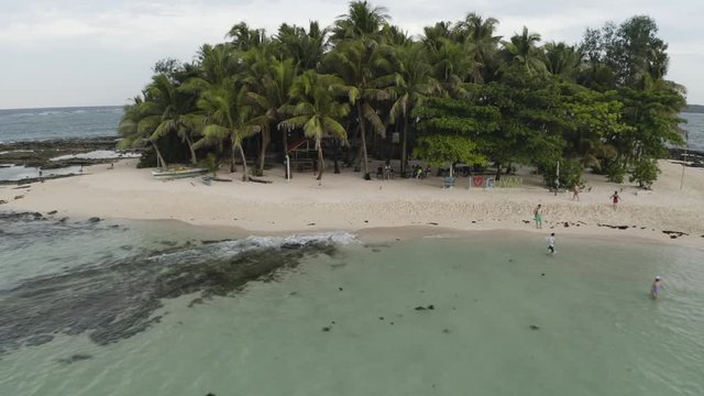 4K Aerial Footage Flying over a small passenger boat that is Island Hopping in tropical paradise philippines guyam Island Siargao