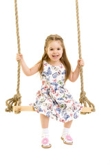 Little girl swinging on a swing