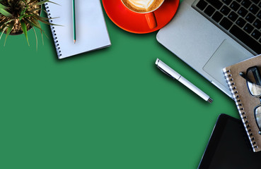 Office equipment, laptop, tablet, pens, smartphone, notebooks and coffee cups on a Sea green background Top view from the top.