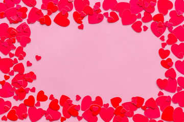 Frame with hearts for present carts design on pink background top view copyspace