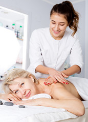 Woman having professional massage in spa salon