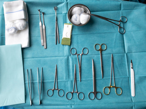 various surgical instruments lie on an operating table