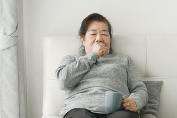 Asian senior woman have a cough at home, lifestyle concept.