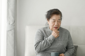 Asian senior woman have a cough at home, lifestyle concept. - obrazy, fototapety, plakaty