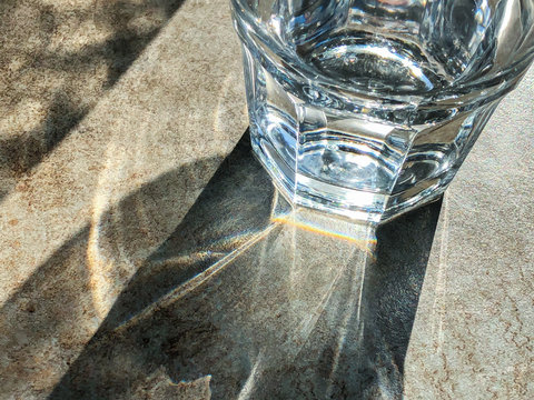 glass of mineral water on stone background of table at outdoor restaurant. top view