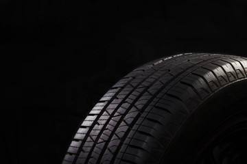 Tire on black bckground with copy space. © happy_author