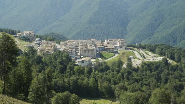 Aerial view of ski resort and alpine village in Mountains in summer sunny day