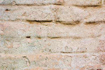 Texture of a brick wall with cracks and scratches which can be used as a background