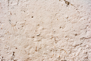 Texture of a concrete wall with cracks and scratches which can be used as a background