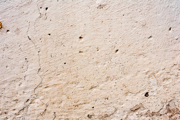 Texture of a concrete wall with cracks and scratches which can be used as a background
