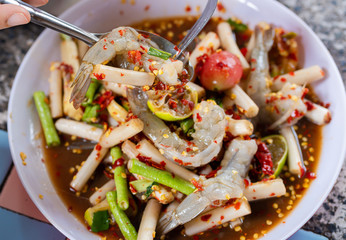 Papaya salad or what we called in Thai Som Tum with lotus stem is the popular Thai style local the eastern delicious famous food of Thailand