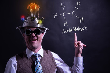Nerd presenting handdrawn chemical formula of acetaldehyde molecule