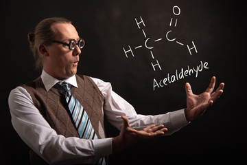 Professor presenting handdrawn chemical formula of acetaldehyde molecule