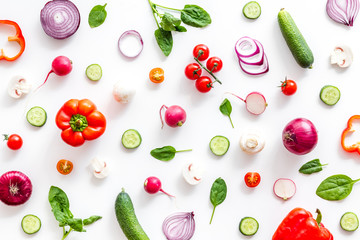 Layout of colorful vegetables on white background top view pattern