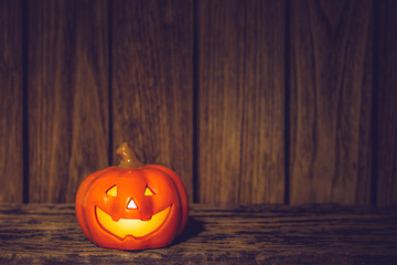 Halloween Pumpkins  jack o lanterns with funny faces on grunge wood at night. Halloween background with copy space for your advertisement text