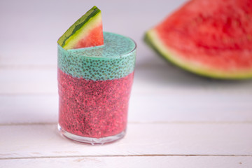 Glass of black chia pudding with watermelon taste