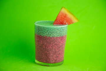 Glass of black chia pudding with watermelon taste