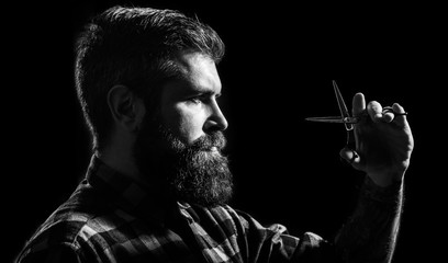 Brutal male, hipster with moustache. Male in barbershop, haircut, shaving. Mans haircut in barber shop. Profile of stylish beard man, scissors. Barber scissors, barber shop. Black and white