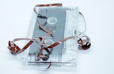 Old audio cassette tape located on a white background