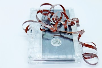 Old audio cassette tape located on a white background