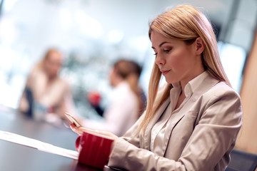 Business woman using phone in office
