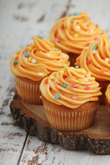 Cupcakes with orange icing on top	