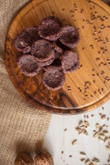 Sweets on a wooden tray around which are natural ingredients. Sugar-free dessert, healthy eating. Candies for diabetics.