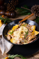 Colorful farfalle pasta with chanterelles and cream sauce.