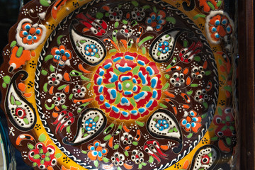 Handmade multicolored souvenir plate made by Sheki craftsmen