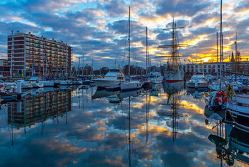 Cityscape of the yacht marina harbor at sunset in the city center of Ostend (Oostende in Flemish) by the North Sea, Belgium.