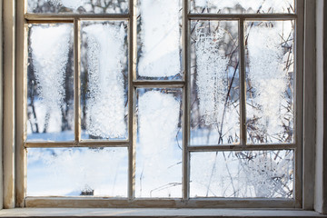 old wooden window with winter frost