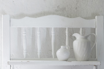 Fototapeta na wymiar two ceramic pitchers on old wooden shelf