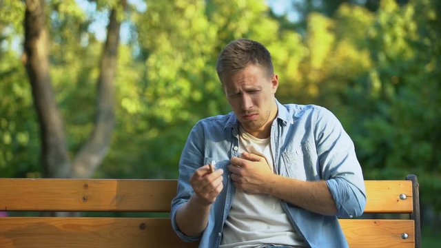 Young man hardly coughing after smoking cigarette, chronic bronchitis disease