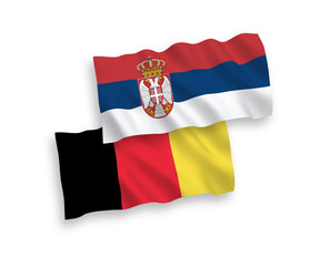 National vector fabric wave flags of Serbia and Belgium isolated on white background. 1 to 2 proportion.