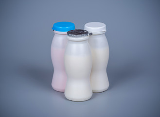 Three plastic bottles with yogurt