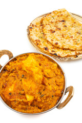 Indian Vegetarian Cuisine Special Sweet And Spicy Paneer Pasanda or Stuffed Paneer Curry, Delicacy Consisting of Stuffed Paneer with Rich Creamy Gravy Served With Garlic Naan on White Background