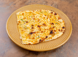 Indian Healthy Cuisine Garlic Bread Also Know as Garlic Naan, Coriander Naan, Indian Flat bread or Garlic Nan Served in a Plate on Vintage Background