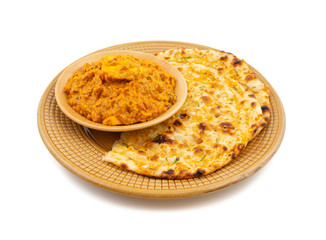 Indian Vegetarian Cuisine Special Sweet And Spicy Paneer Pasanda or Stuffed Paneer Curry, Delicacy Consisting of Stuffed Paneer with Rich Creamy Gravy Served With Garlic Naan on White Background